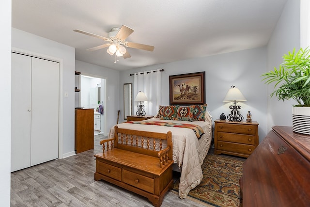 bedroom with ensuite bathroom, baseboards, wood finished floors, a closet, and ceiling fan
