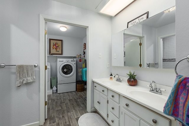 full bathroom with washing machine and dryer, wood finished floors, a sink, and double vanity