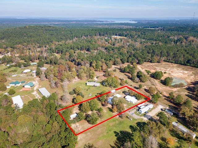 bird's eye view featuring a wooded view