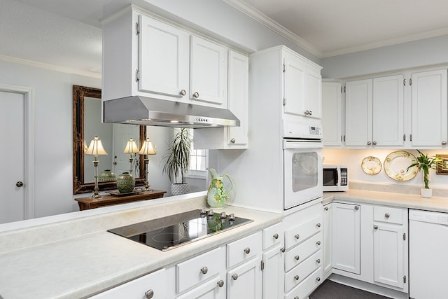 kitchen with white cabinets, under cabinet range hood, white appliances, and crown molding