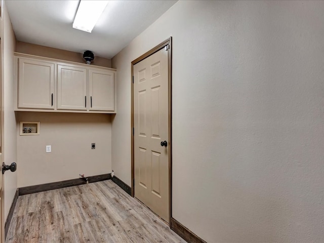 laundry area featuring cabinet space, baseboards, light wood-style floors, and hookup for an electric dryer