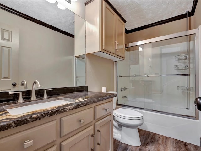 full bath featuring crown molding, vanity, a textured ceiling, and wood finished floors