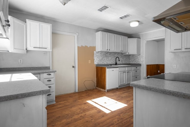 kitchen featuring sink, white cabinetry, white dishwasher, dark hardwood / wood-style flooring, and exhaust hood