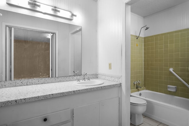 full bathroom featuring toilet, vanity, tile patterned flooring, and tiled shower / bath