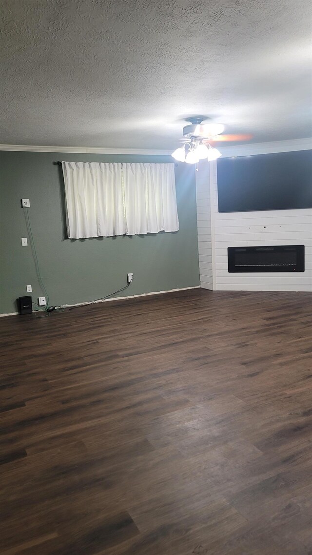 unfurnished living room featuring a fireplace, a textured ceiling, and dark hardwood / wood-style floors