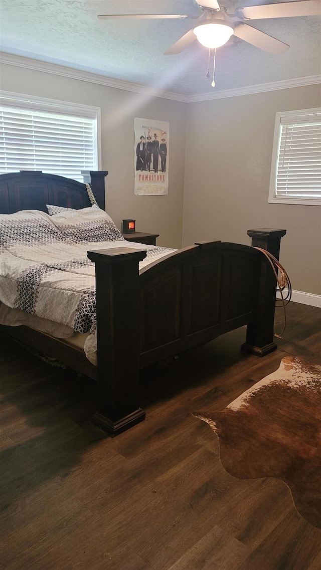 bedroom featuring ceiling fan, dark hardwood / wood-style flooring, and ornamental molding