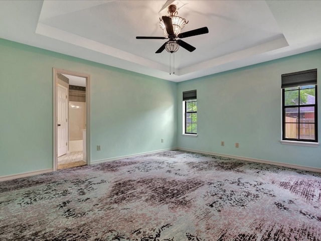 602 April Dr, Lufkin, TX 75904 - spare room featuring a raised ceiling, carpet floors, and a ceiling fan