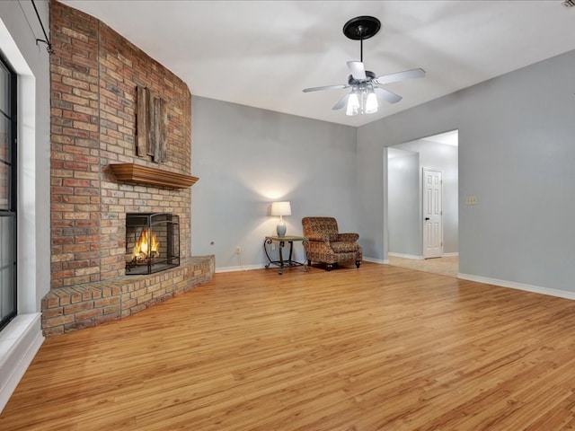 602 April Dr, Lufkin, TX 75904 - sitting room with light wood-style flooring, ceiling fan, and a brick fireplace