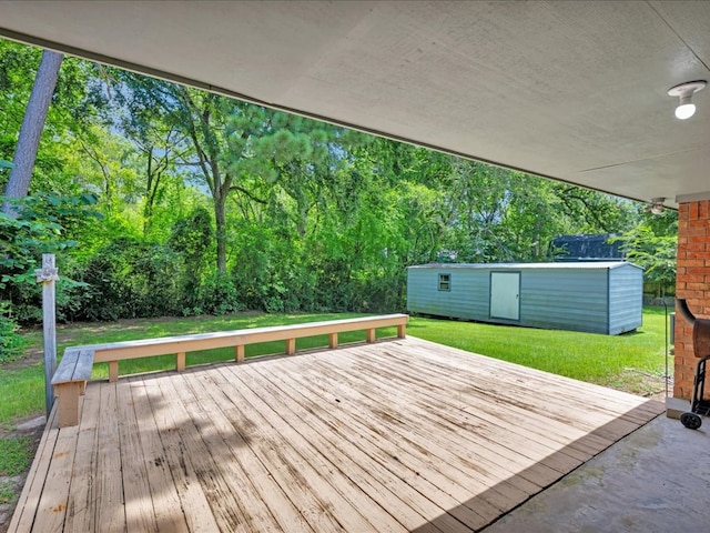 602 April Dr, Lufkin, TX 75904 - wooden terrace featuring a lawn, an outdoor structure, and view of wooded area