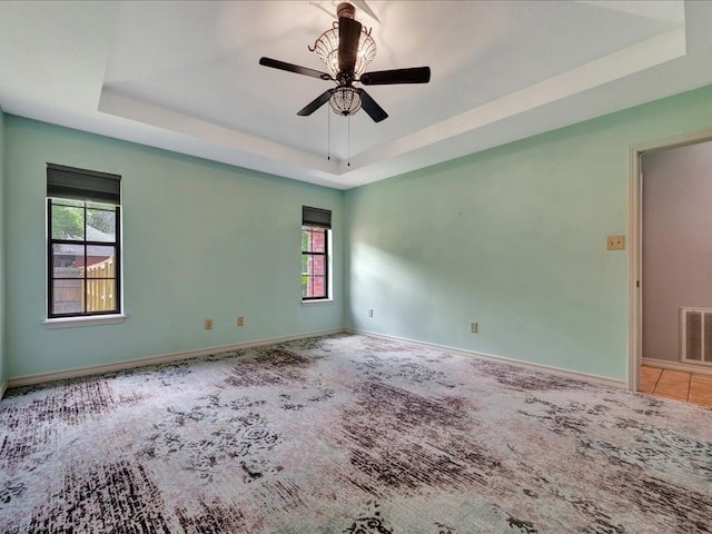 602 April Dr, Lufkin, TX 75904 - spare room featuring a raised ceiling, a ceiling fan, and carpet floors