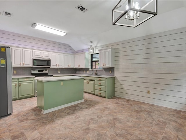 602 April Dr, Lufkin, TX 75904 - kitchen with appliances with stainless steel finishes, green cabinets, vaulted ceiling, light countertops, and a kitchen island