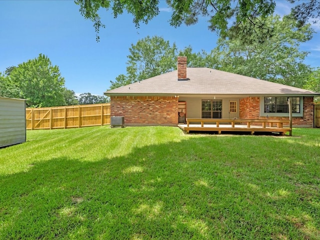 602 April Dr, Lufkin, TX 75904 - back of property featuring brick siding, a chimney, and a deck