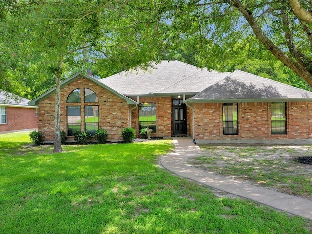 602 April Dr, Lufkin, TX 75904 - single story home with a front yard, roof with shingles, and brick siding