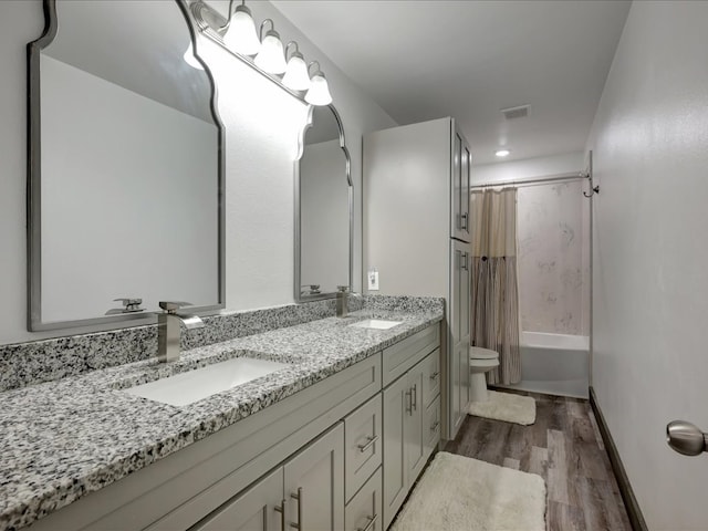 516 Westchester St, Diboll, TX 75941 - full bathroom with toilet, double vanity, wood finished floors, shower / tub combo, and recessed lighting
