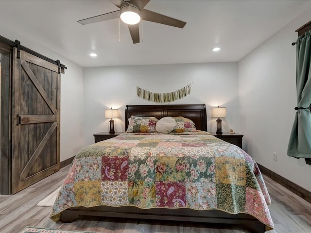 516 Westchester St, Diboll, TX 75941 - bedroom featuring a barn door, light wood finished floors, baseboards, recessed lighting, and a ceiling fan