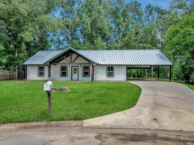 516 Westchester St, Diboll, TX 75941 - view of front facade featuring a carport, metal roof, and driveway