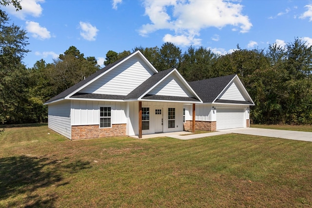 view of front facade with a garage, covered porch, and a front yard