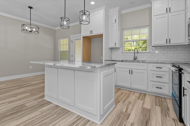 kitchen with a kitchen island, sink, pendant lighting, white cabinetry, and black electric range oven