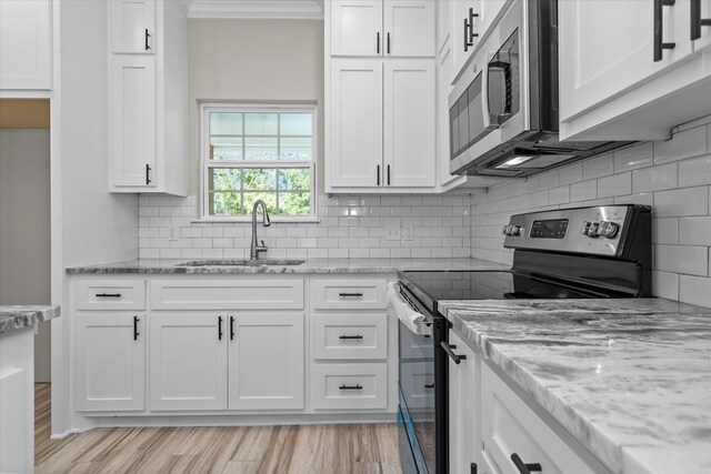 kitchen featuring sink, white cabinets, and stainless steel appliances