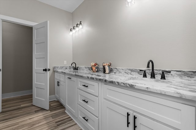 bathroom featuring hardwood / wood-style flooring and vanity