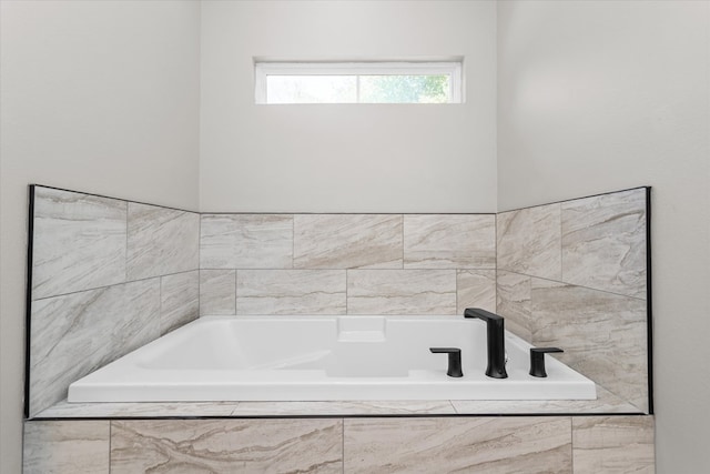 bathroom featuring a relaxing tiled tub