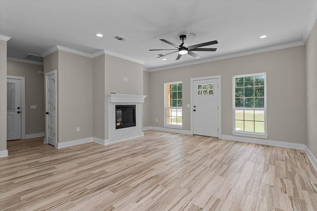 unfurnished living room featuring a fireplace, light wood-type flooring, ceiling fan, and ornamental molding