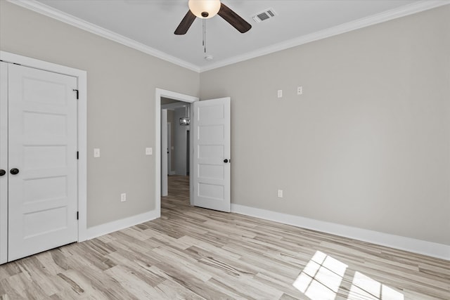 unfurnished bedroom with ceiling fan, light hardwood / wood-style floors, ornamental molding, and a closet