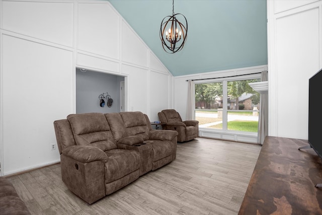 1504 Azalea Dr, Lufkin, TX 75904 - living area with a chandelier, light wood finished floors, and high vaulted ceiling