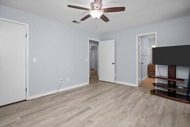 1504 Azalea Dr, Lufkin, TX 75904 - unfurnished bedroom featuring wood finished floors, baseboards, ensuite bathroom, and ceiling fan