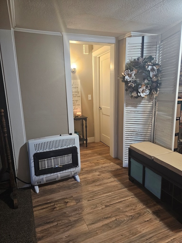 2606 Brentwood Dr, Lufkin, TX 75901 - detailed view of heating unit, wood finished floors, a textured ceiling, and ornamental molding