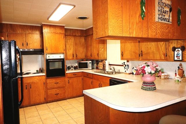 kitchen featuring sink, kitchen peninsula, light tile patterned flooring, black appliances, and ornamental molding