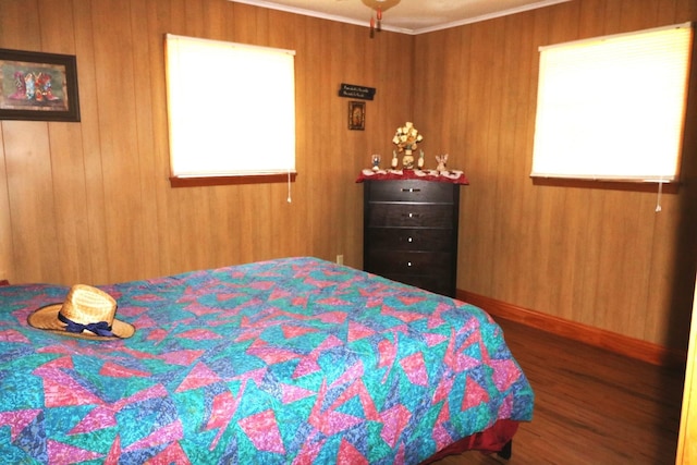 bedroom featuring wood-type flooring and wooden walls