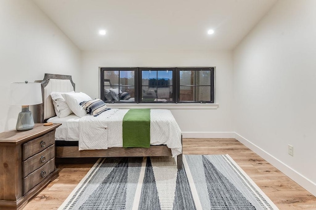 bedroom featuring recessed lighting, baseboards, light wood-type flooring, and lofted ceiling