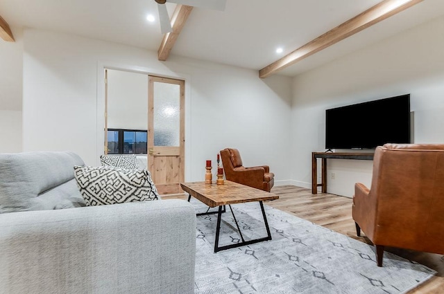 living room with recessed lighting, light wood-type flooring, beam ceiling, and baseboards