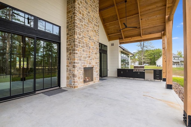 view of patio featuring area for grilling and a grill