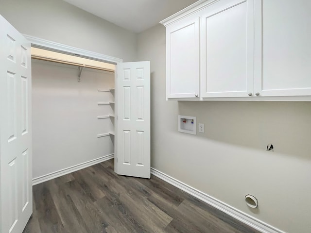 washroom with hookup for a washing machine, baseboards, cabinet space, and dark wood-type flooring