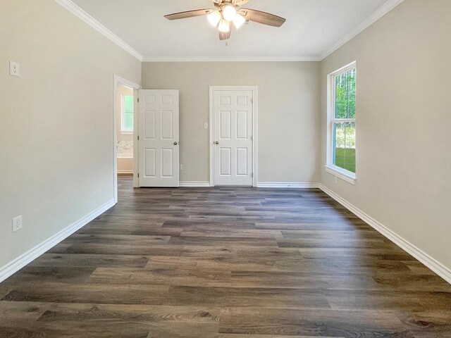 unfurnished room featuring baseboards, dark wood finished floors, ceiling fan, and crown molding