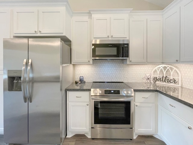 kitchen featuring white cabinets, stainless steel appliances, and decorative backsplash