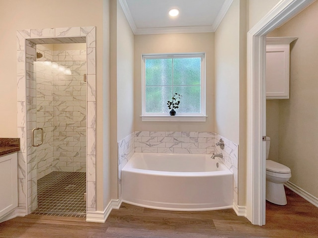 full bath featuring a shower stall, a garden tub, ornamental molding, and wood finished floors