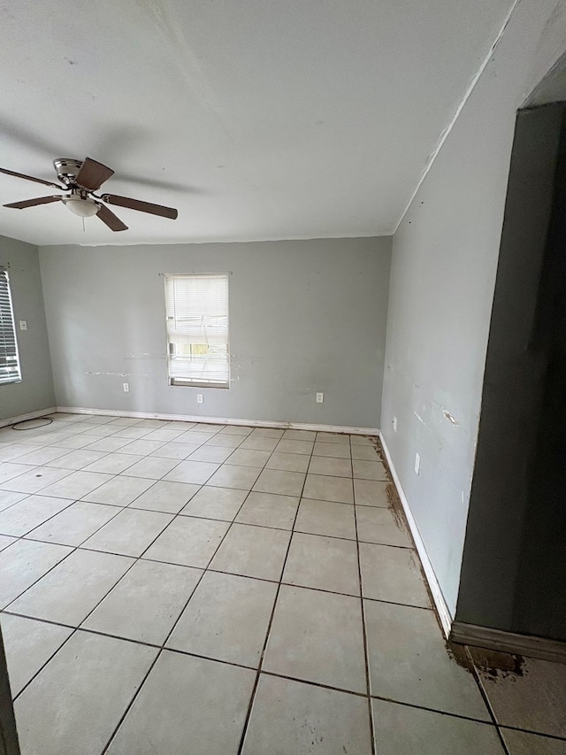 unfurnished room featuring light tile patterned floors and ceiling fan