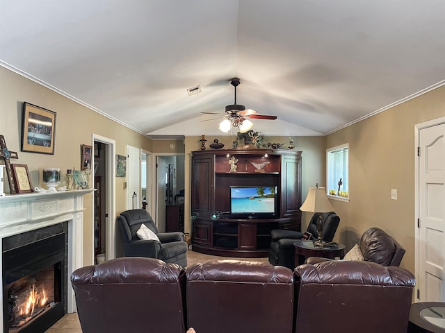 living room featuring ceiling fan, ornamental molding, and vaulted ceiling