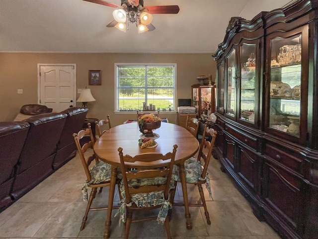 dining area with ceiling fan and crown molding