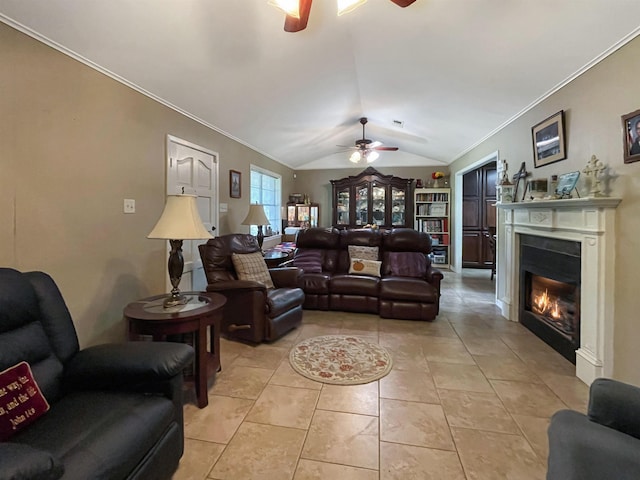 tiled living room with vaulted ceiling, ceiling fan, and ornamental molding