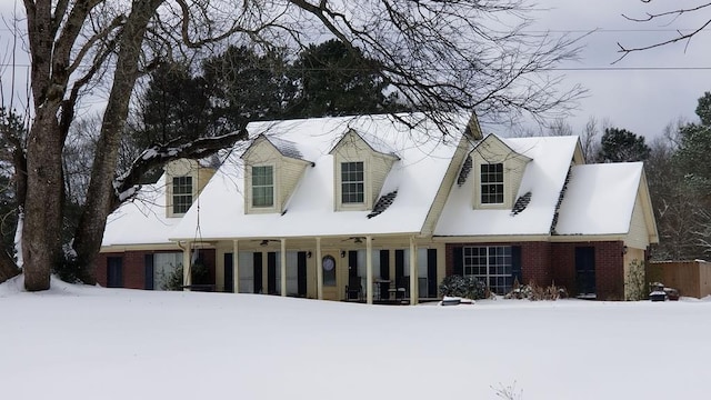 cape cod home with brick siding