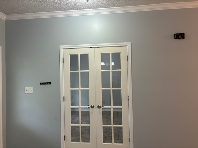 entryway featuring ornamental molding, french doors, and a textured ceiling