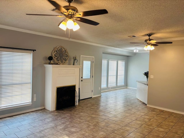 unfurnished living room with a textured ceiling, ornamental molding, a ceiling fan, and baseboards