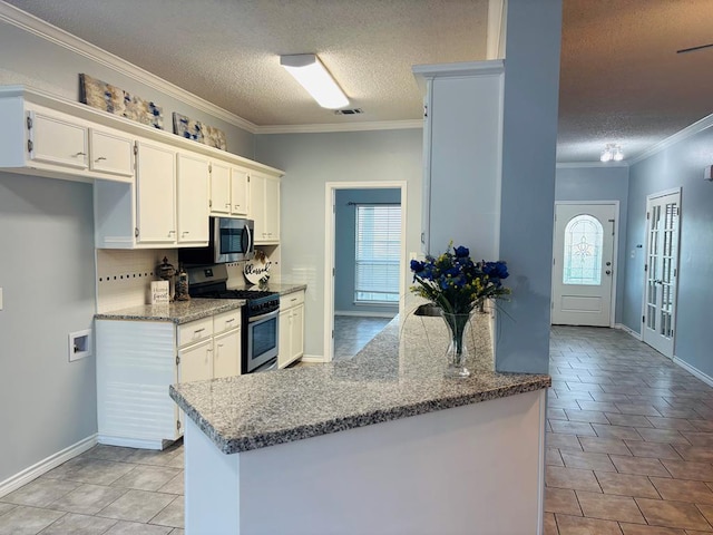 kitchen with crown molding, light tile patterned floors, stainless steel appliances, white cabinets, and a textured ceiling