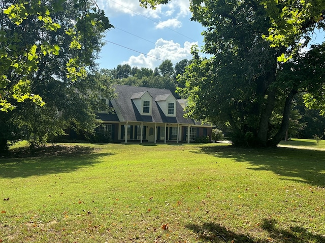 cape cod-style house featuring a front lawn