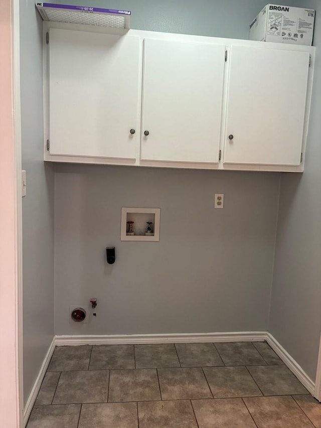 laundry room with hookup for a washing machine, hookup for a gas dryer, cabinet space, and baseboards