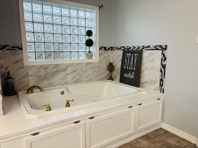 full bathroom featuring a jetted tub, tile patterned flooring, and baseboards